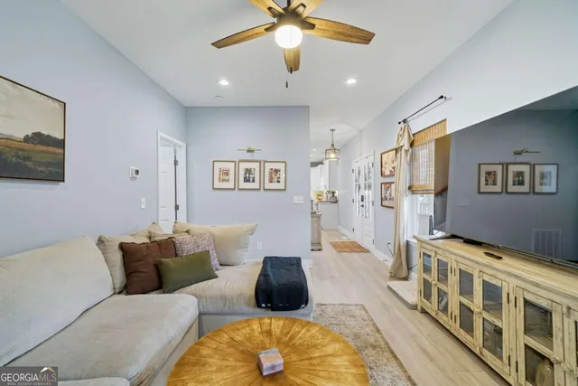 a living room with furniture and a chandelier
