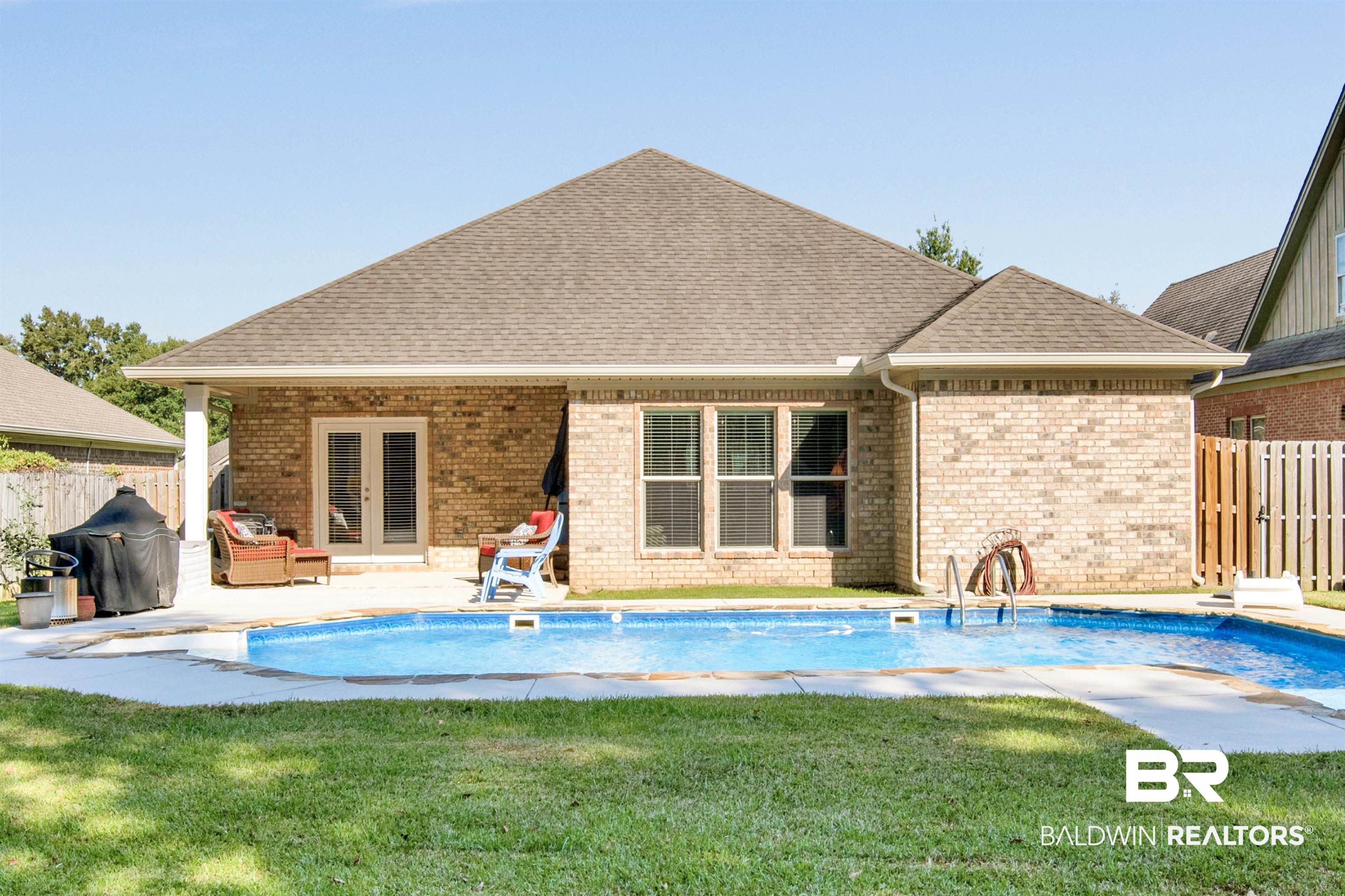 360 Scarlett Avenue Fairhope, AL 36532 - Photo 32 of 34 Back of house featuring a lawn, a patio, and a fenced in pool