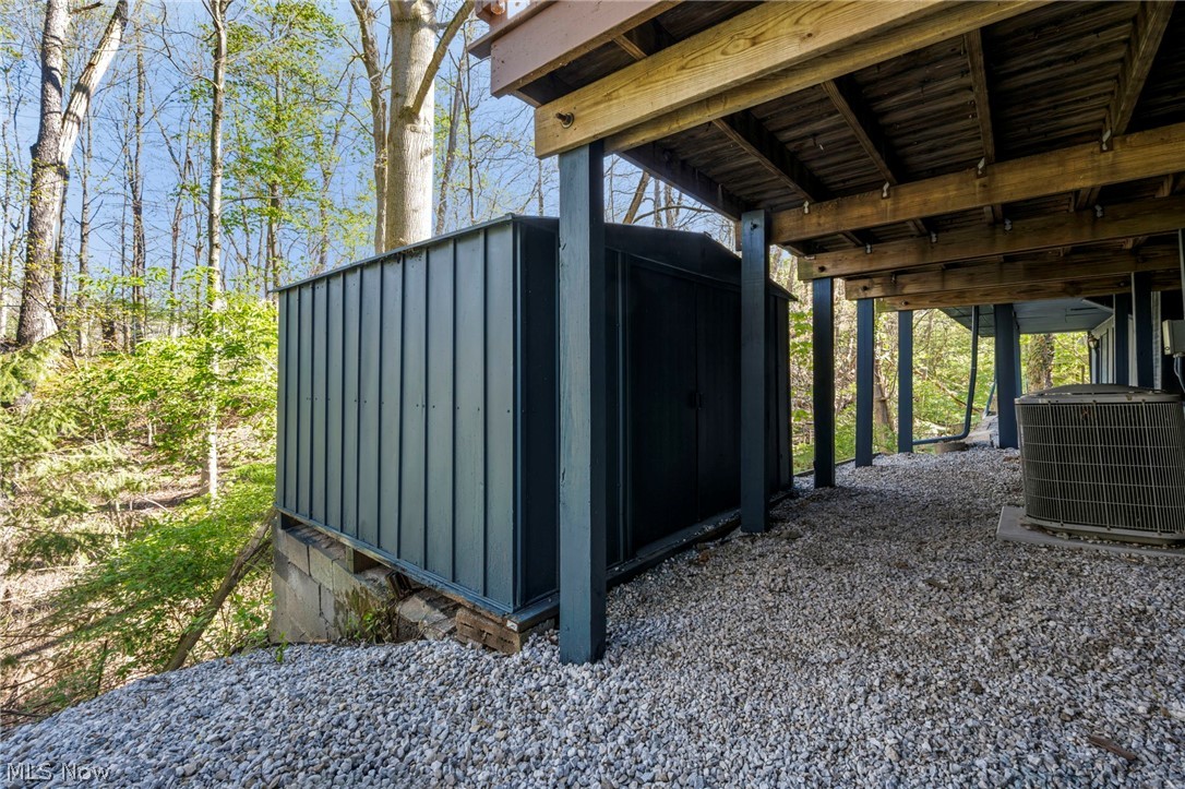 7339 River Road Olmsted Falls, OH 44138 - Photo 43 of 45 Under-deck storage structure with corrugated metal siding and double doors