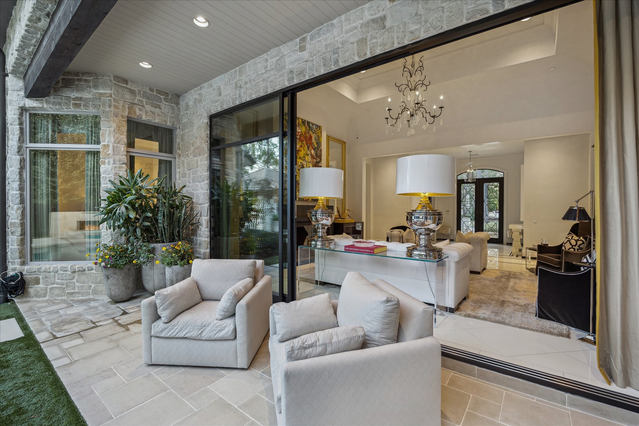 220 Merrie Way Lane Houston, TX 77024 - Photo 46 of 50 A closer look at the custom sliding Fleetwood doors reveals their expansive connection to the covered outdoor patio from the formal living room.