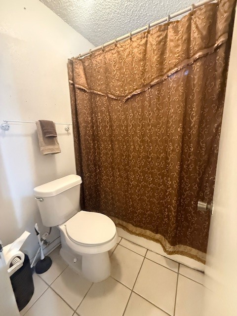 16714 Rockbend Houston, TX 77084 - Photo 12 of 19 a white toilet sitting next to a shower curtain