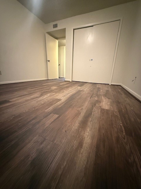 16714 Rockbend Houston, TX 77084 - Photo 16 of 19 an empty room with wooden floor and windows