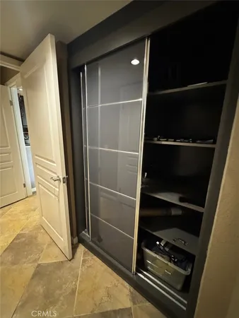 a bedroom with a bed a dresser and a large window