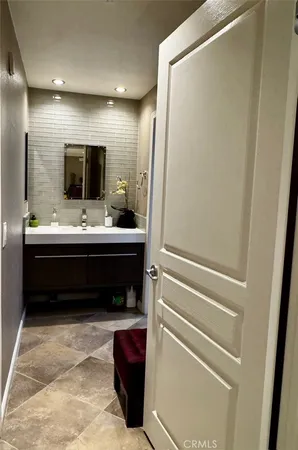 a living room with kitchen countertops and a flat screen tv