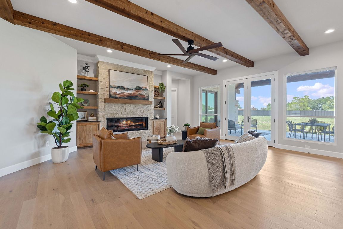 713 San Gabriel Ranch Road Liberty Hill, TX 78642 - Photo 13 of 40 a living room with furniture and a fireplace