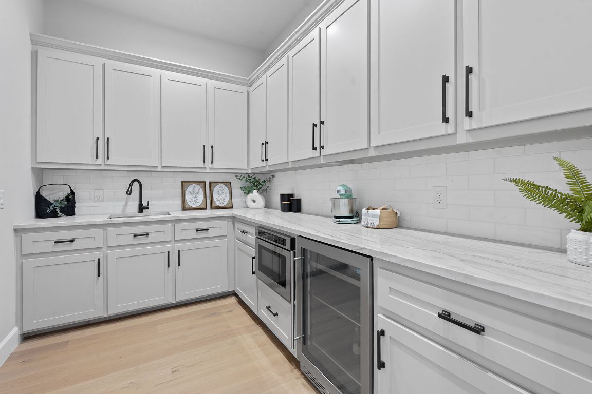 713 San Gabriel Ranch Road Liberty Hill, TX 78642 - Photo 19 of 40 a kitchen with granite countertop white cabinets and white appliances