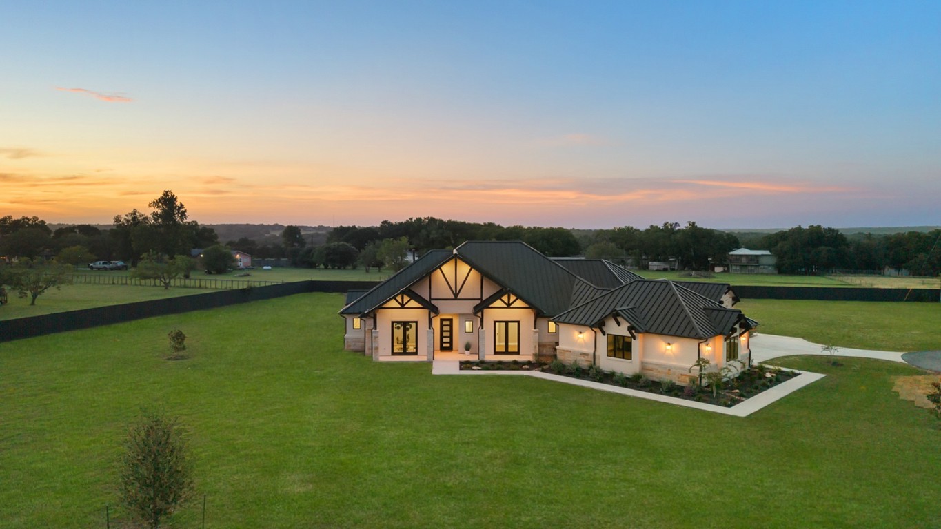 713 San Gabriel Ranch Road Liberty Hill, TX 78642 - Photo 2 of 40 a view of a table and chairs with the view of a lake