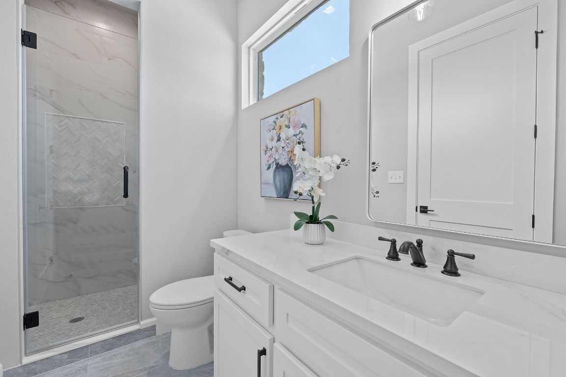 713 San Gabriel Ranch Road Liberty Hill, TX 78642 - Photo 25 of 40 Bathroom featuring vanity and a marble finish shower