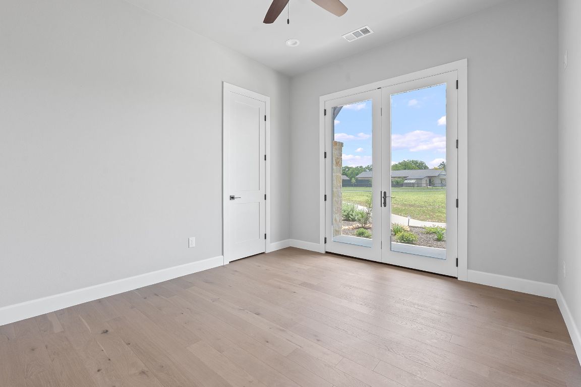 713 San Gabriel Ranch Road Liberty Hill, TX 78642 - Photo 27 of 40 wooden floor in an empty room with a window