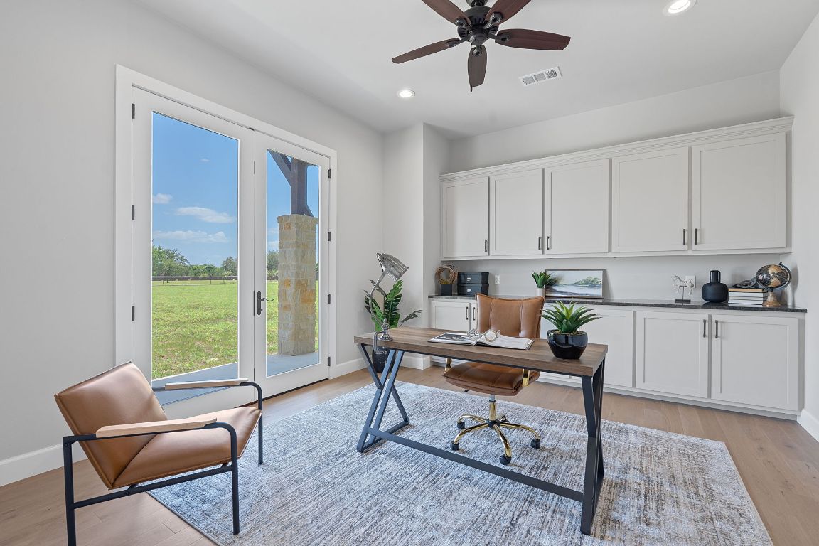 713 San Gabriel Ranch Road Liberty Hill, TX 78642 - Photo 29 of 40 a workspace with wooden floor and a window