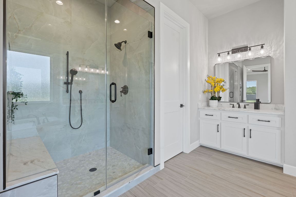 713 San Gabriel Ranch Road Liberty Hill, TX 78642 - Photo 32 of 40 a bathroom with a shower sink and mirror