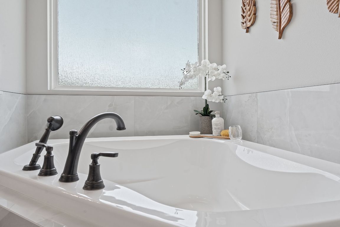 713 San Gabriel Ranch Road Liberty Hill, TX 78642 - Photo 33 of 40 a bathroom with a sink and a mirror