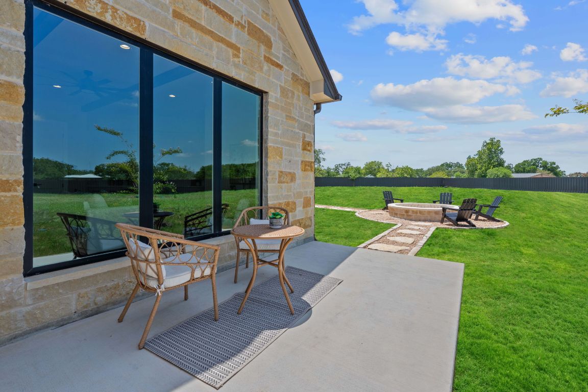 713 San Gabriel Ranch Road Liberty Hill, TX 78642 - Photo 38 of 40 a view of a patio with a table chairs and garden