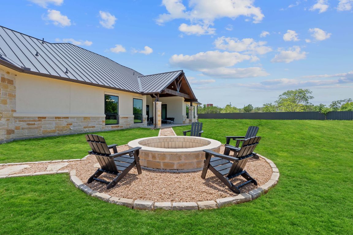 713 San Gabriel Ranch Road Liberty Hill, TX 78642 - Photo 39 of 40 a view of a patio with table and chairs with wooden fence