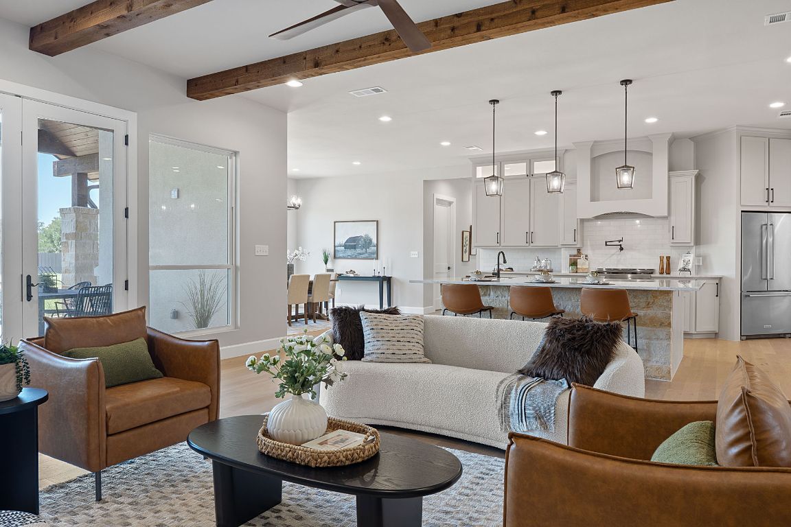713 San Gabriel Ranch Road Liberty Hill, TX 78642 - Photo 4 of 40 a view of a living room kitchen and a dining table with kitchen view