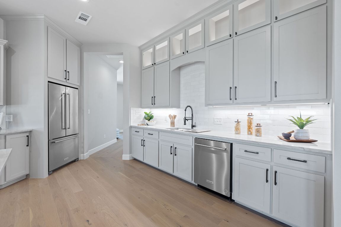 713 San Gabriel Ranch Road Liberty Hill, TX 78642 - Photo 10 of 40 a kitchen with white cabinets and white appliances