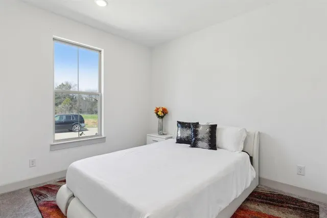 a bedroom with a bed and window