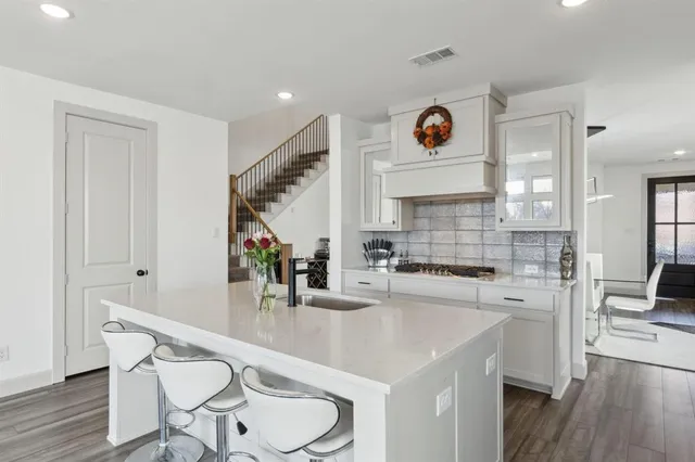 a large white kitchen with a large window