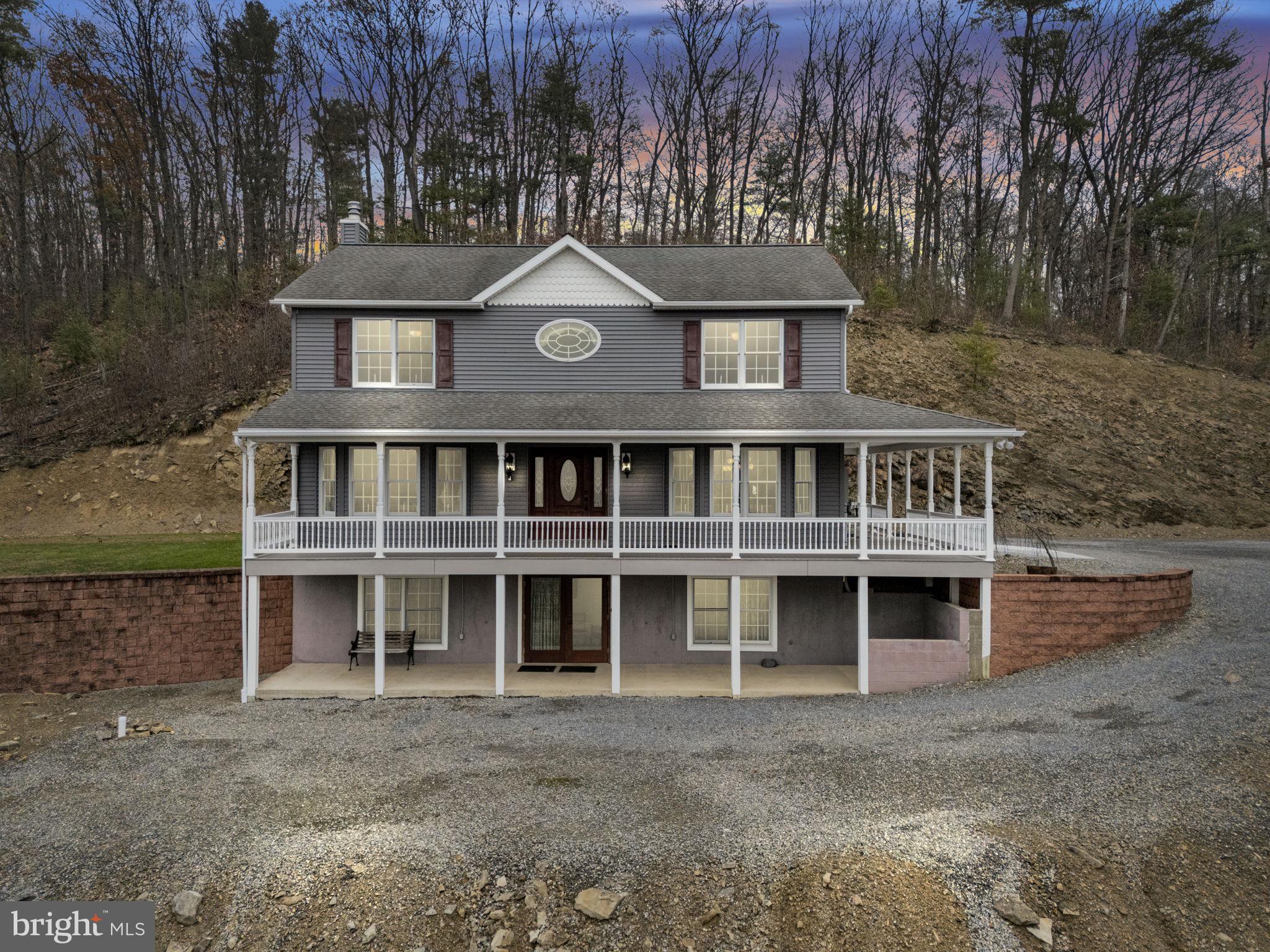 a front view of a house with a garden and balcony