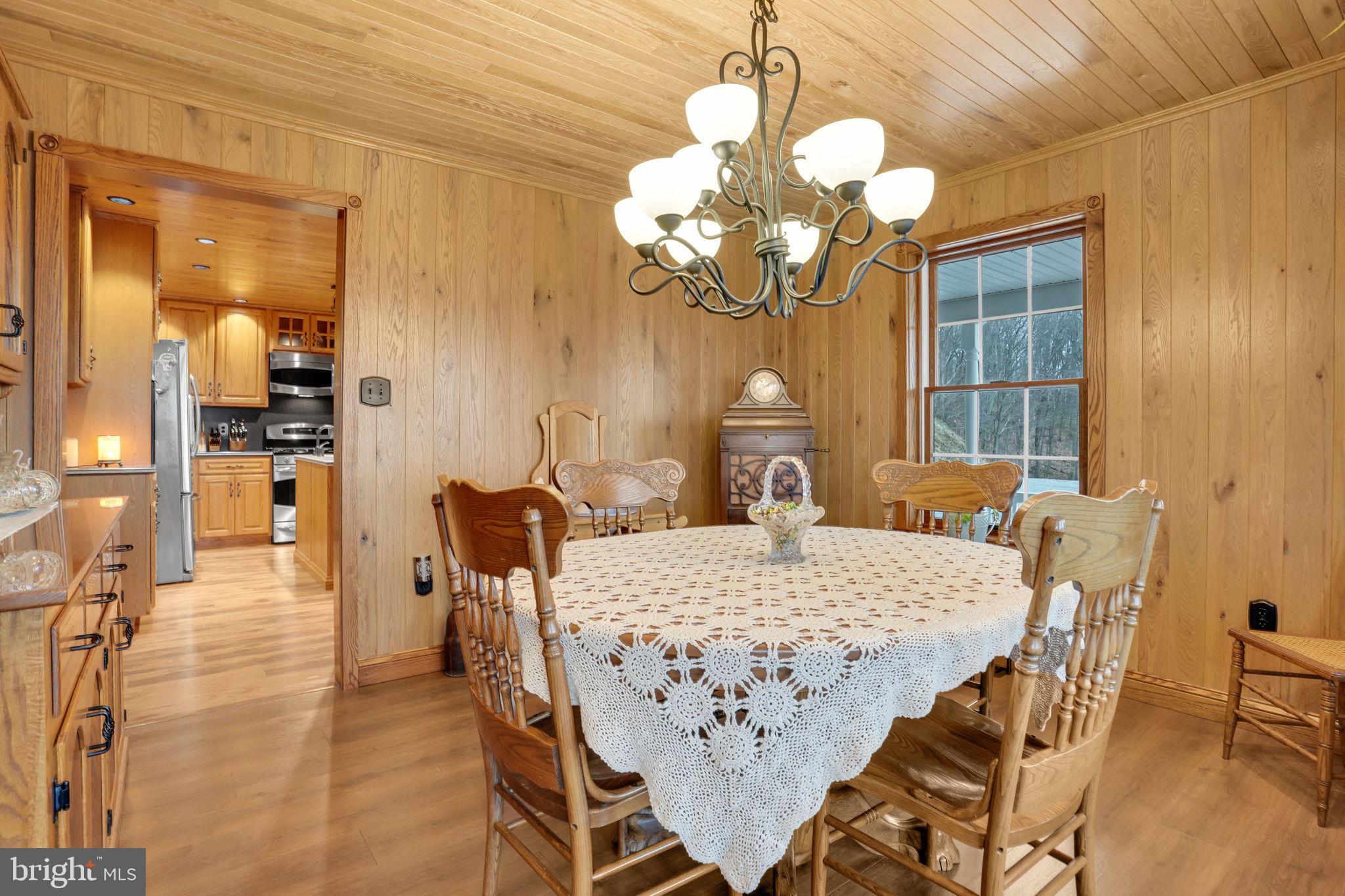 7848 Rte 104 Mount Pleasant Mills, PA 17853 - Photo 14 of 54 a view of a dining room with furniture and chandelier