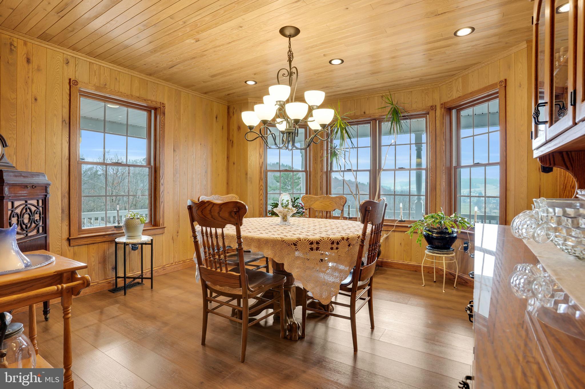 7848 Rte 104 Mount Pleasant Mills, PA 17853 - Photo 15 of 54 a dining room with wooden floor a chandelier a wooden table and chairs