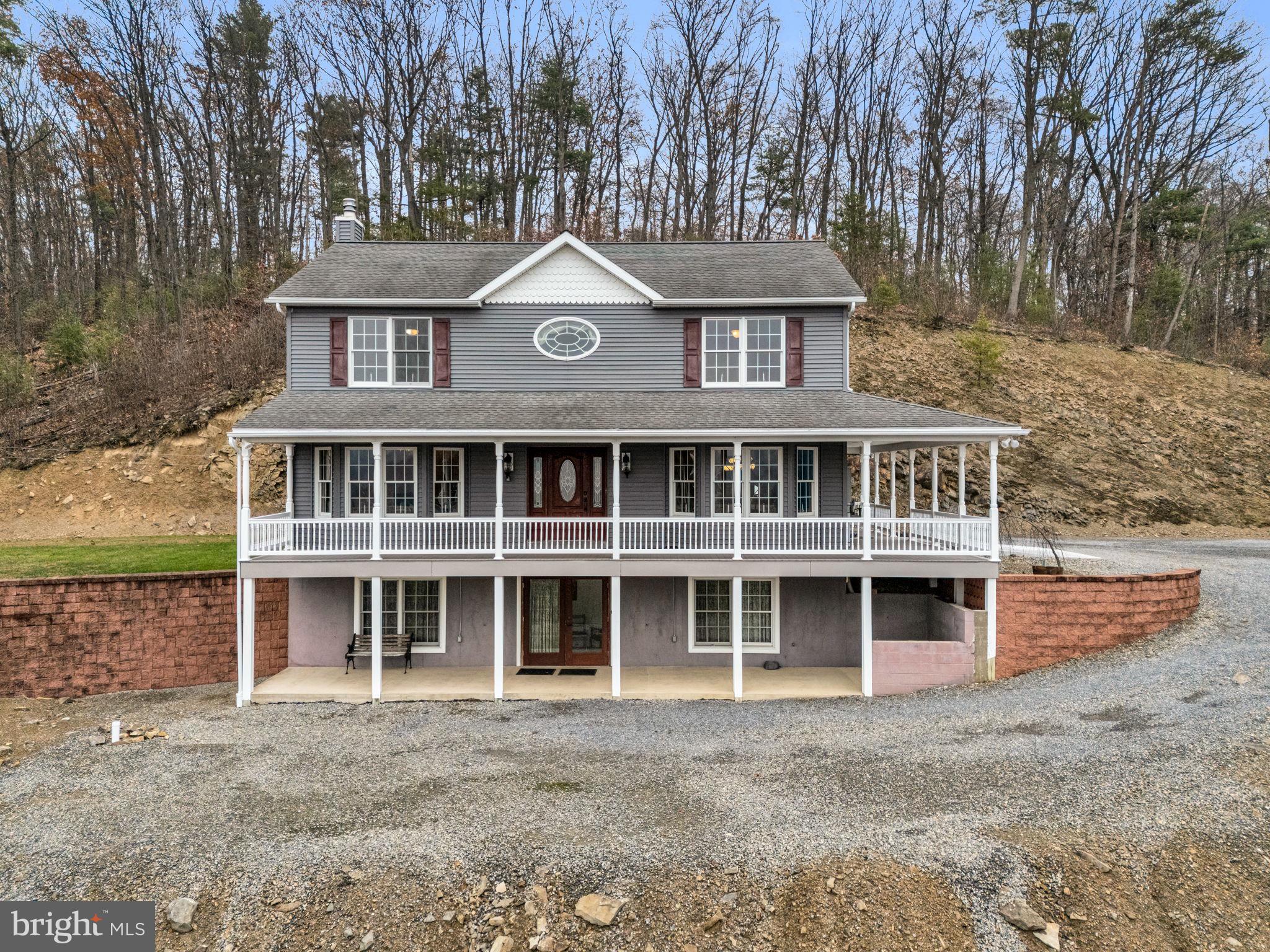 7848 Rte 104 Mount Pleasant Mills, PA 17853 - Photo 2 of 54 a front view of a house with a yard and garage