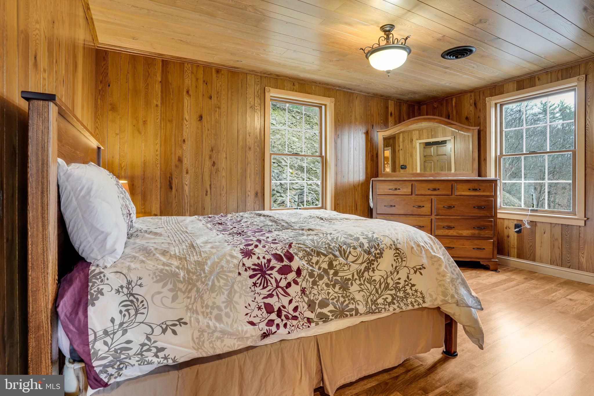 7848 Rte 104 Mount Pleasant Mills, PA 17853 - Photo 28 of 54 a bedroom with a bed and a dresser with mirror