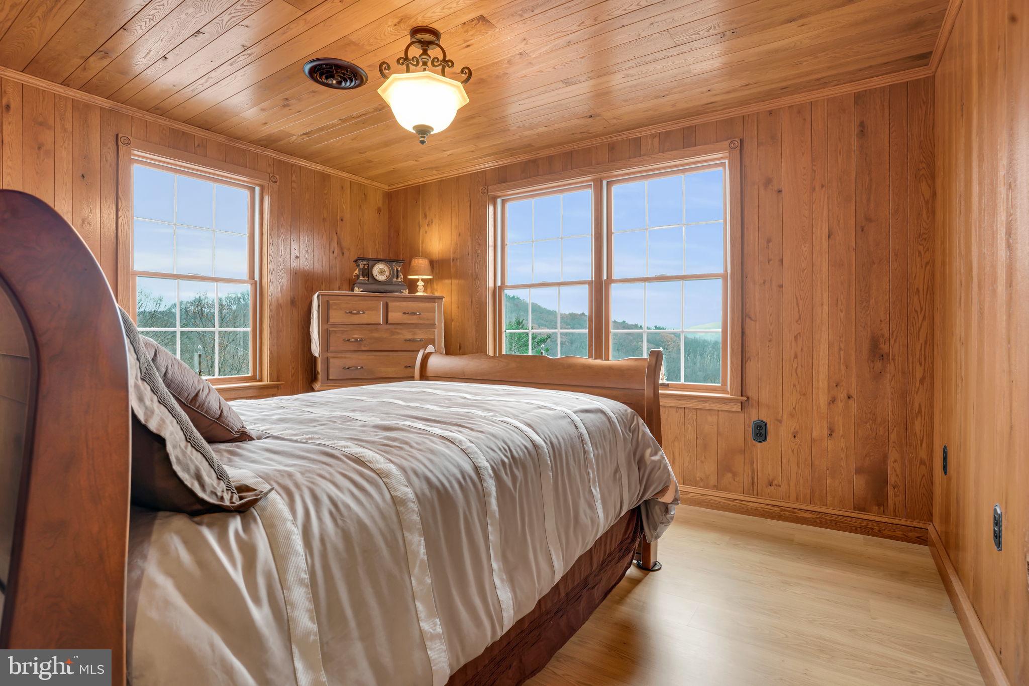 7848 Rte 104 Mount Pleasant Mills, PA 17853 - Photo 29 of 54 a bedroom with a large bed and a large window