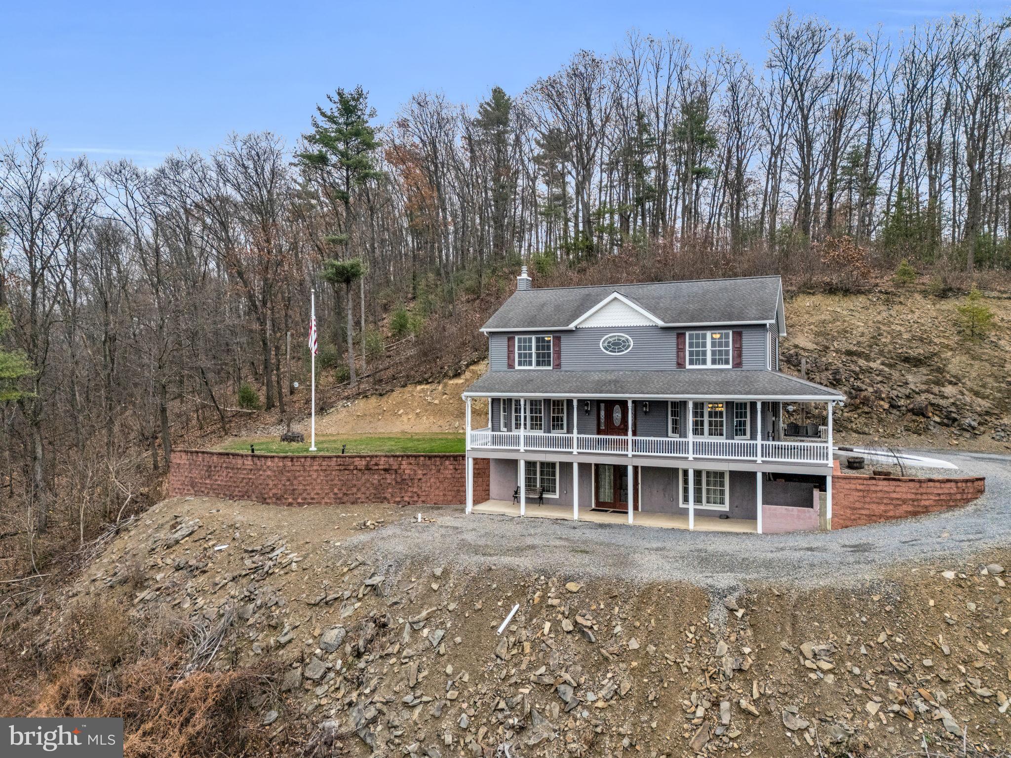 7848 Rte 104 Mount Pleasant Mills, PA 17853 - Photo 3 of 54 a front view of a house with a garden