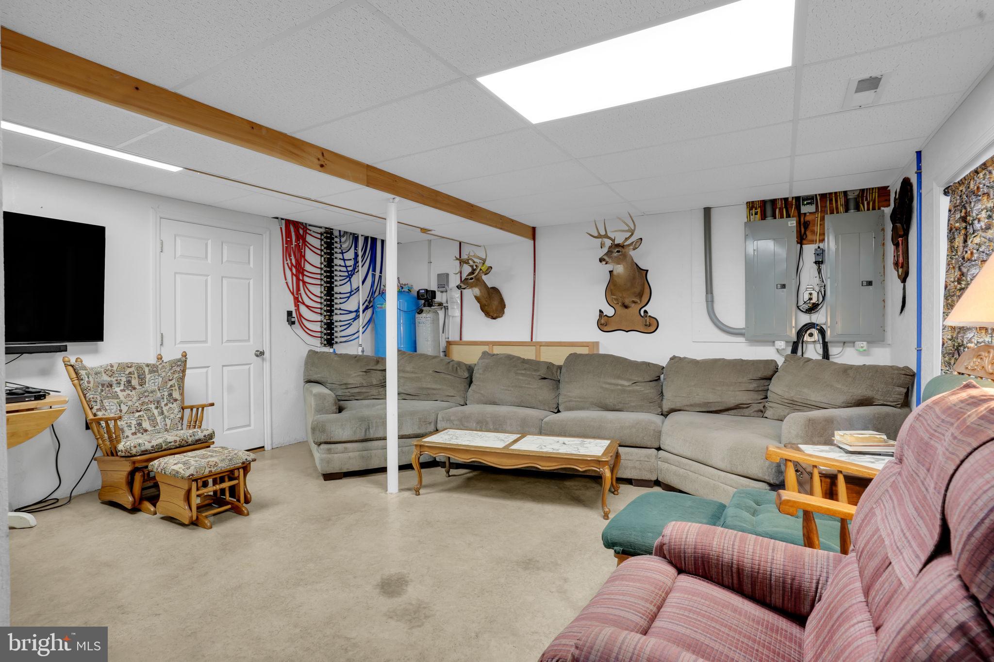 7848 Rte 104 Mount Pleasant Mills, PA 17853 - Photo 35 of 54 a living room with furniture and a flat screen tv