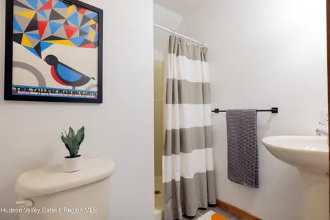 a bathroom with a sink and mirror with bathtub