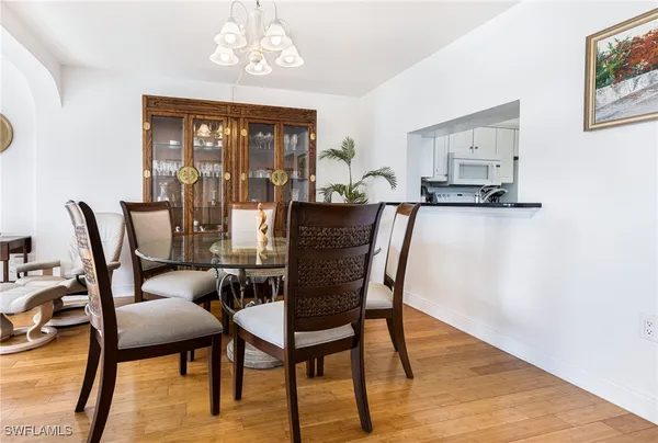 a view of a dining room with furniture wooden floor and a chandelier