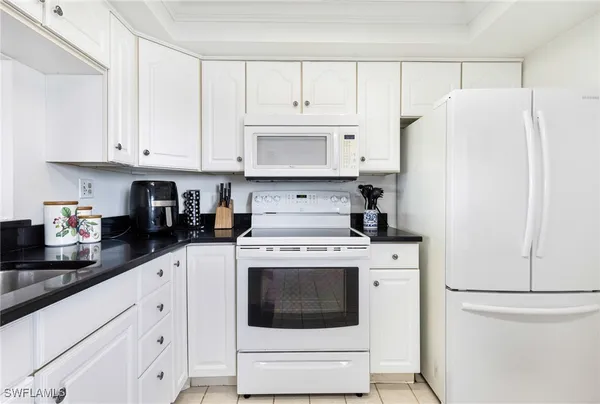 a kitchen with cabinets appliances and a counter space