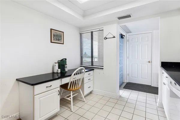 a kitchen with granite countertop a sink cabinets and window