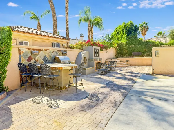 a view of a swimming pool with outdoor seating