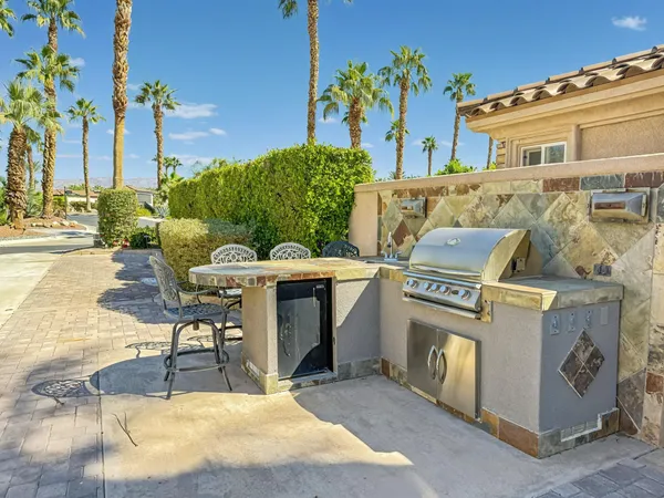 a view of a patio with table and chairs and potted plants
