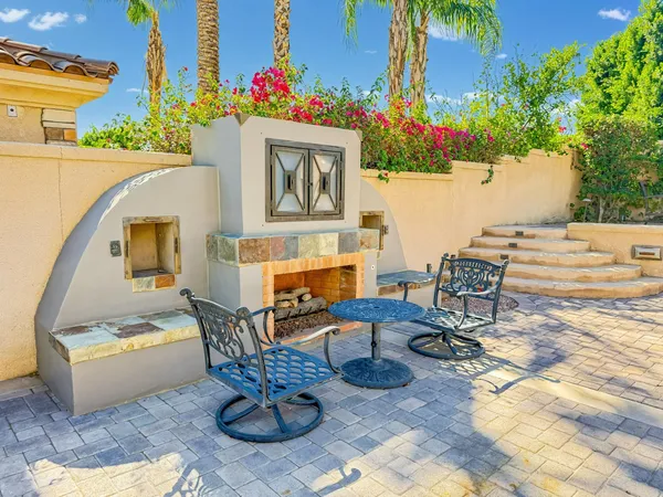 a building outdoor space with patio furniture and potted plants