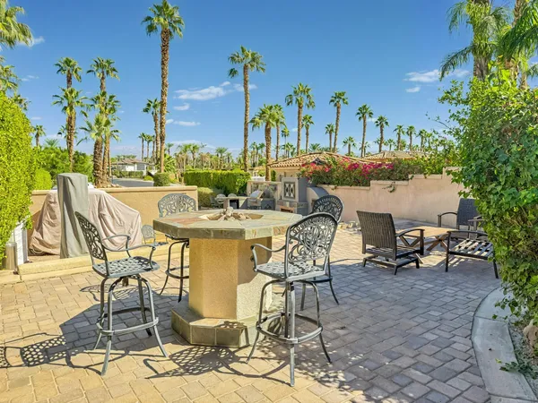 a view of a swimming pool with outdoor seating