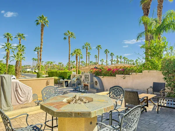 a view of a swimming pool and outdoor seating