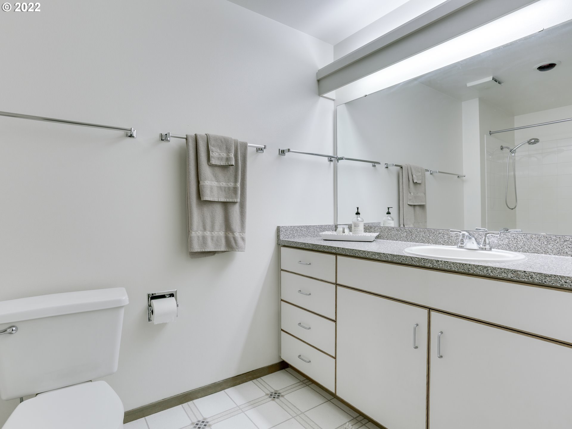 1730 South Harbor Way, Unit 405 Portland, OR 97201 - Photo 16 of 32 a bathroom with a granite countertop sink mirror vanity and toilet