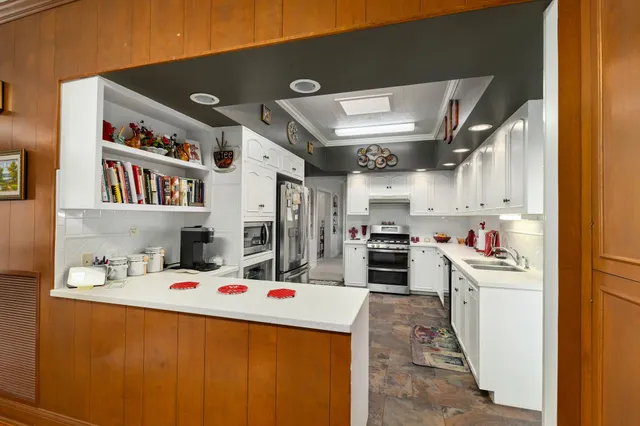 a kitchen that has a lot of cabinets a washer and dryer