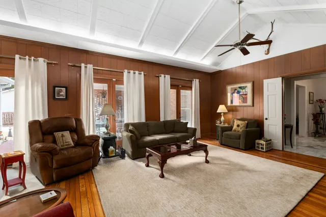 a living room with furniture gym equipment and a large window