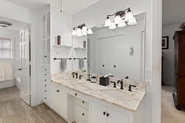a bathroom with double vanity sinks a vanity a mirror and a shower