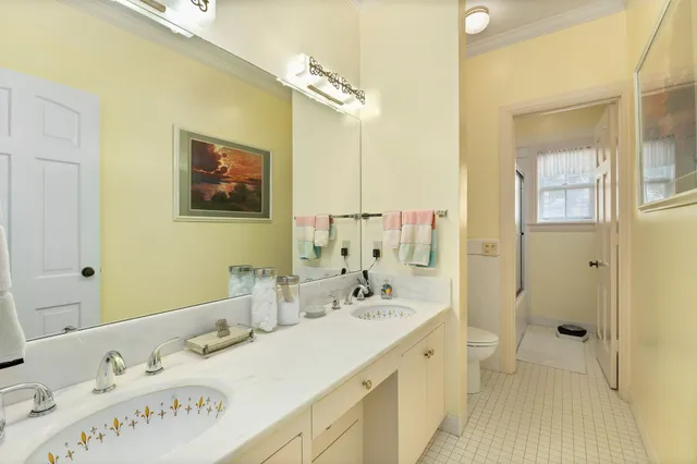 a spacious bathroom with a tub sink and mirror