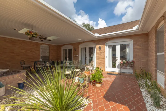 a view of a hall with dining area and chandelier