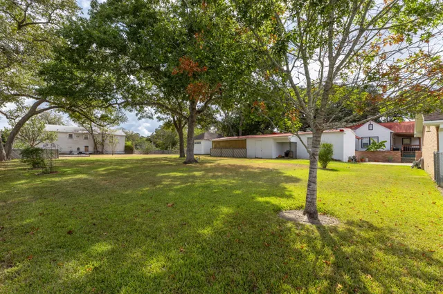 a view of a back yard of the house with green space