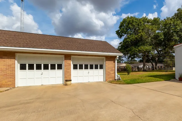 a utility room with fridge and clutter