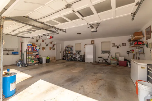 a view of a house with a yard and large trees