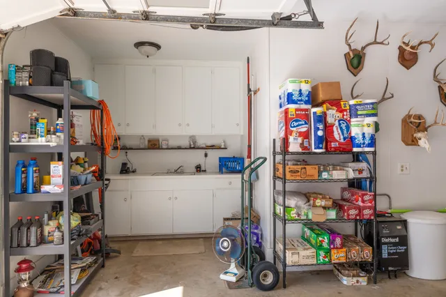 a front view of a house with a garden and trees