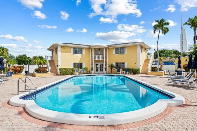 a view of a swimming pool with outdoor seating